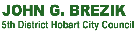 John G. Brezik Logo